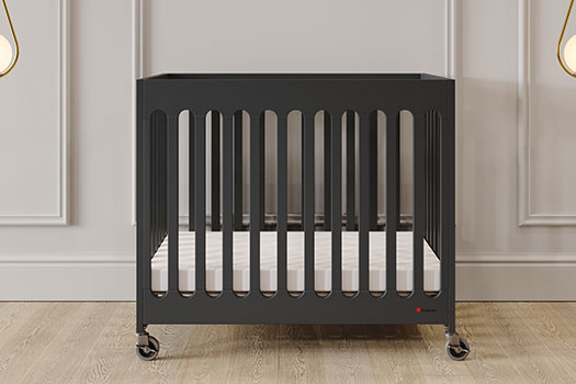 The Boutique Fold Away Crib by Foundations made of solid wood