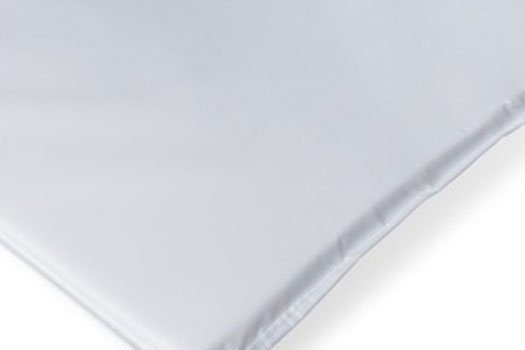 Changing table includes antimicrobial mattress pad